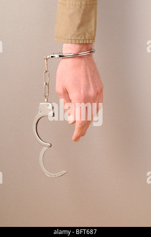 Handcuffs on Man's Wrist Stock Photo