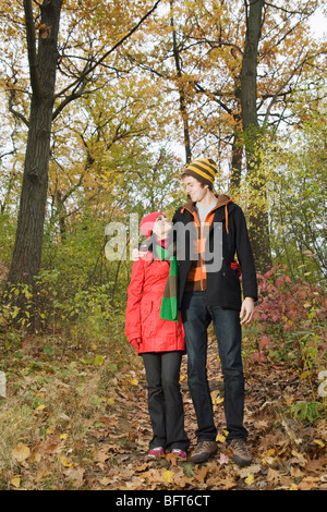 Couple Walking in Forest in Autumn Stock Photo