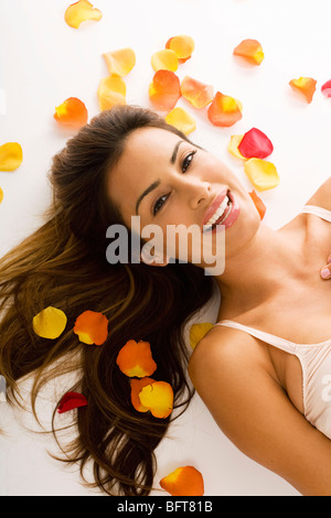 Woman Surrounded by Flower Petals Stock Photo