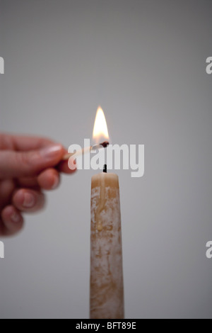 Lighting Candle Stock Photo