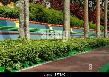 Colorful or Colourful Blue, Green, Purple & Orange Wall, and Row of Trees, Tiger Balm Gardens Chinese Theme Park or Public Garden Singapore Stock Photo