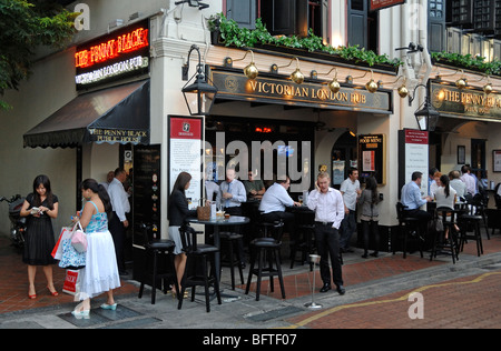 Office Workers Drinking in the Penny Black, Victorian London Pub, an English or British Theme Bar, on Boat Quay, Singapore Stock Photo