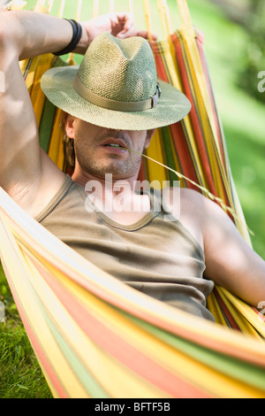 Man sleeping in a hammock Stock Photo