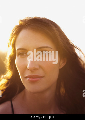 woman on the beach enjoying sunset Stock Photo