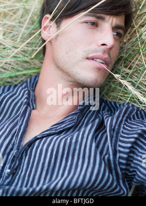 man lying in grass relaxing Stock Photo