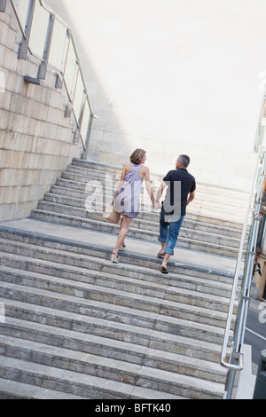 couple walking up stairs Stock Photo
