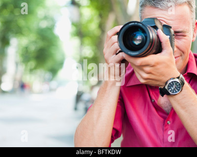 man with camera taking picture Stock Photo