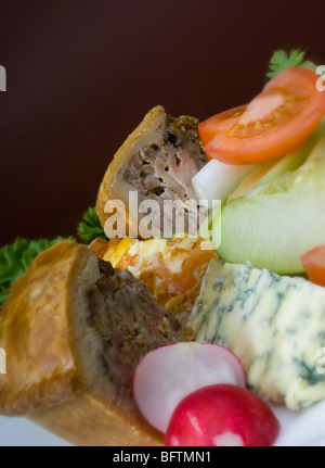 Close-up of Ploughmans Lunch with Pork Pie & Huntsman's Pie also blue cheese and salad Stock Photo