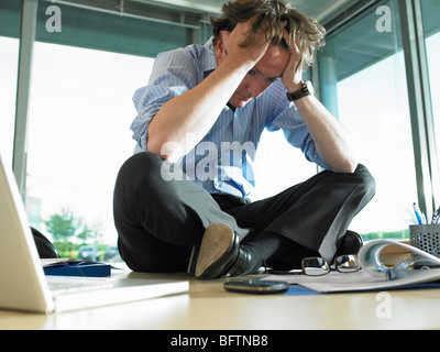 Man on his desk, thinking Stock Photo