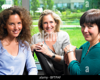 Women looking at camera, smiling Stock Photo
