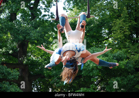 balancing act on trapeze in mid air Stock Photo