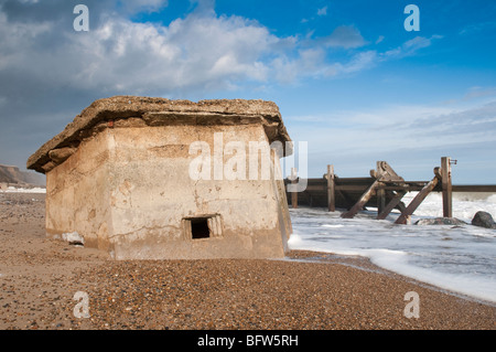 Overturned World War Two pill box on the beach at Happisburgh, Norfolk Stock Photo