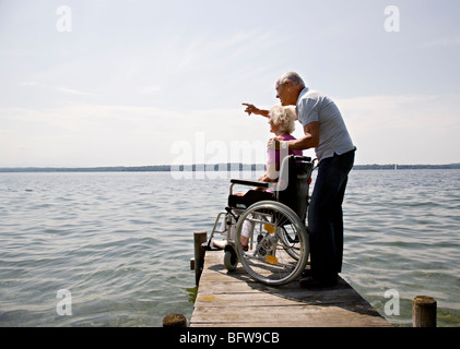 senior man and woman in wheelchair Stock Photo
