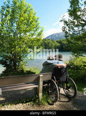 Senior couple relaxing by lake Stock Photo