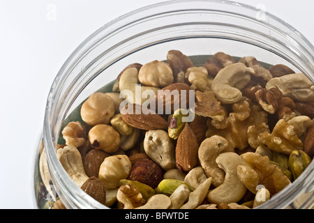 Mixed nuts unsalted in a round plastic jar Stock Photo