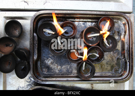 Candles burn in the Gangaramaya temple in Colombo, Sri Lanka. Stock Photo