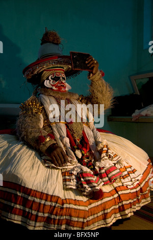 Hanuman, a character in a Kathakali Story-Play, does last changes to his make-up in a theatre in Trivandrum, Kerala. Stock Photo