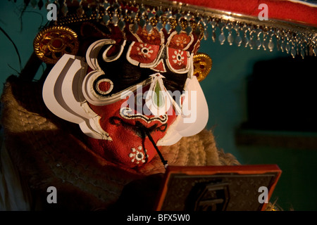 Hanuman, a character in a Kathakali Story-Play, does last changes to his make-up in a theatre in Trivandrum, Kerala. Stock Photo