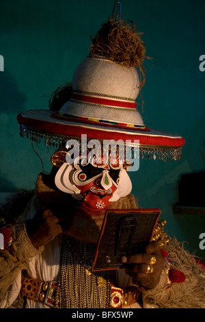 Hanuman, a character in a Kathakali Story-Play, does last changes to his make-up in a theatre in Trivandrum, Kerala. Stock Photo