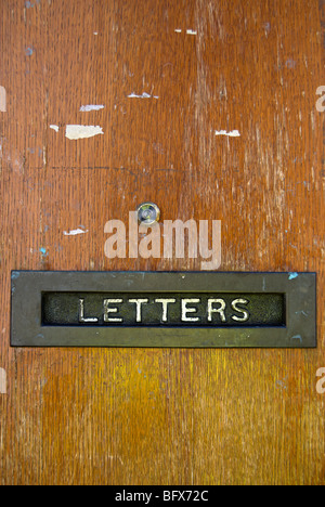 wooden front door with letter box labelled letters and peep hole, in kingston upon thames, surrey, england Stock Photo