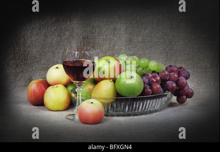 Classical still-life with fruit and a goblet on canvas background Stock Photo