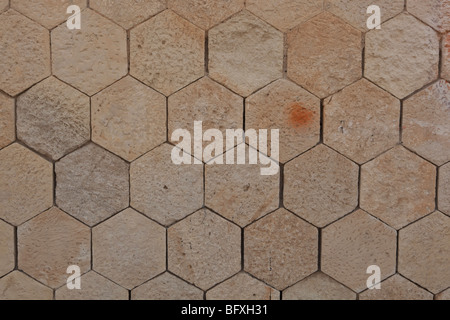 Old hexagonal stone wall tiles on a Venetian building in Crete Stock Photo