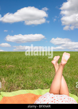 young womans legs in field Stock Photo