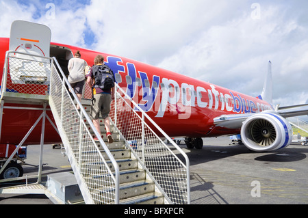 Tourists boarding Pacific Blue/Virgin Australia Boeing 737 at Bauerfield International Airport, Vanuatu, South Pacific. Stock Photo