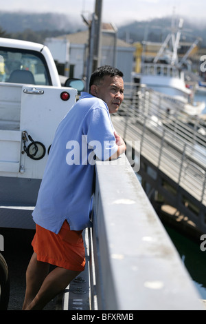 Vietnamese man standing on the pier boardwalk at Monterrey, California. Stock Photo