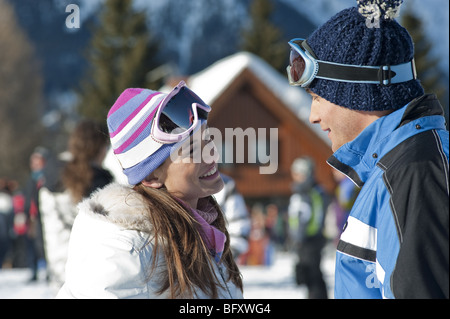 Couple outside of ski lodge Stock Photo