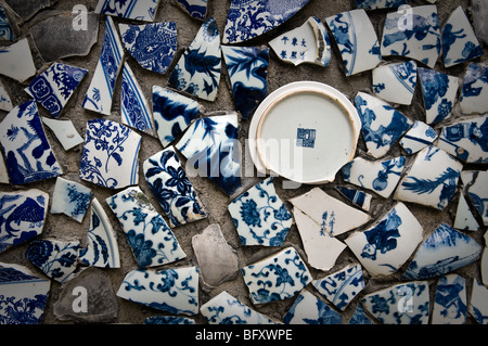 Smashed Chinese pottery on a wall Stock Photo