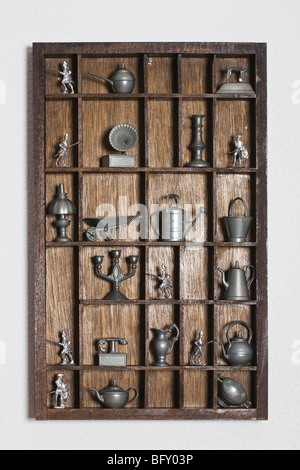 Wooden shelf with tin miniatures Stock Photo