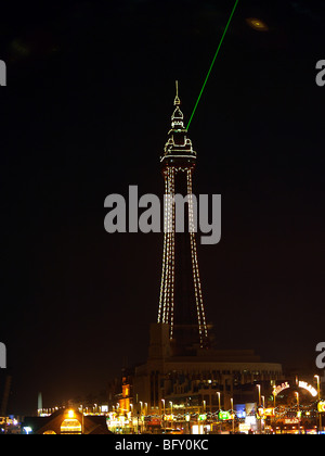 Blackpool tower illuminated against a black sky,with green laser beam and unexpected UFO. Stock Photo