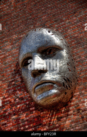 Metal face sculpture on outside wall of Lincoln City Drill Hall, by artist Rick Kirkby. Lincolnshire UK England Stock Photo