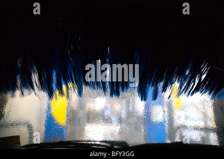 Car in a carwash. View from inside a car as it progresses through an automated car wash. Stock Photo
