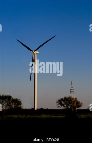 Wind generator and old style windmill that was used for pumping water. Wind generator produces electricity from wind. Stock Photo