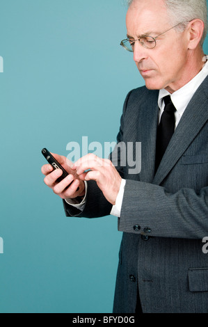 Businessman text messaging on cell phone Stock Photo