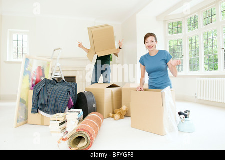 A couple having fun moving home Stock Photo