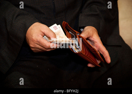 Arabian man filling his wallet Stock Photo