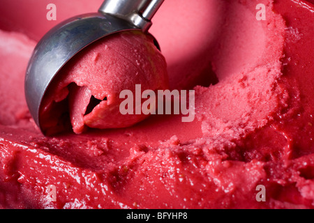 Delicious raspberry ice-cream being scooped out Stock Photo