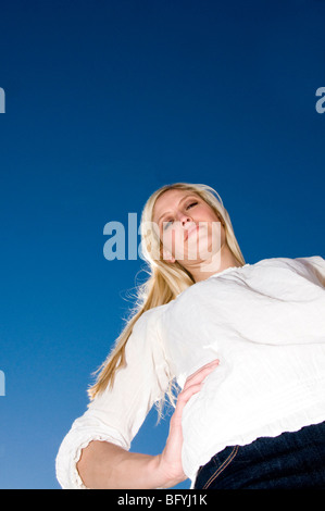 Woman standing with hand on hip Stock Photo
