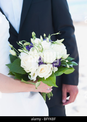 bride and groom holding bridal bouquet Stock Photo