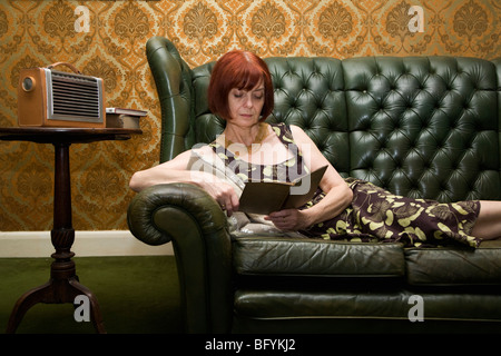 Mature lady reading book Stock Photo
