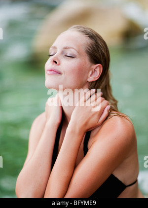 woman sitting on the beach eyes closed Stock Photo