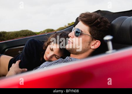 couple lying in car sleeping Stock Photo