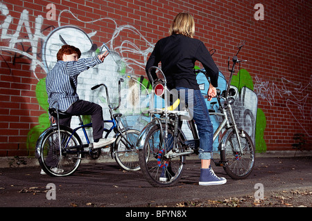 two young boys sitting on chopper bicycles Stock Photo