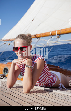 woman smiling lying on deck Stock Photo