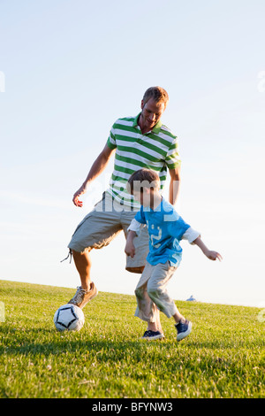 Father and Son Playing Soccer Stock Photo