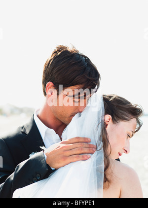 groom embracing bride Stock Photo