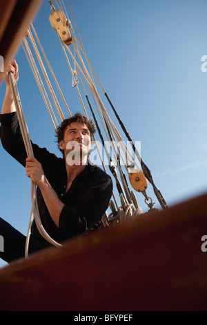 man holding on to ropes Stock Photo